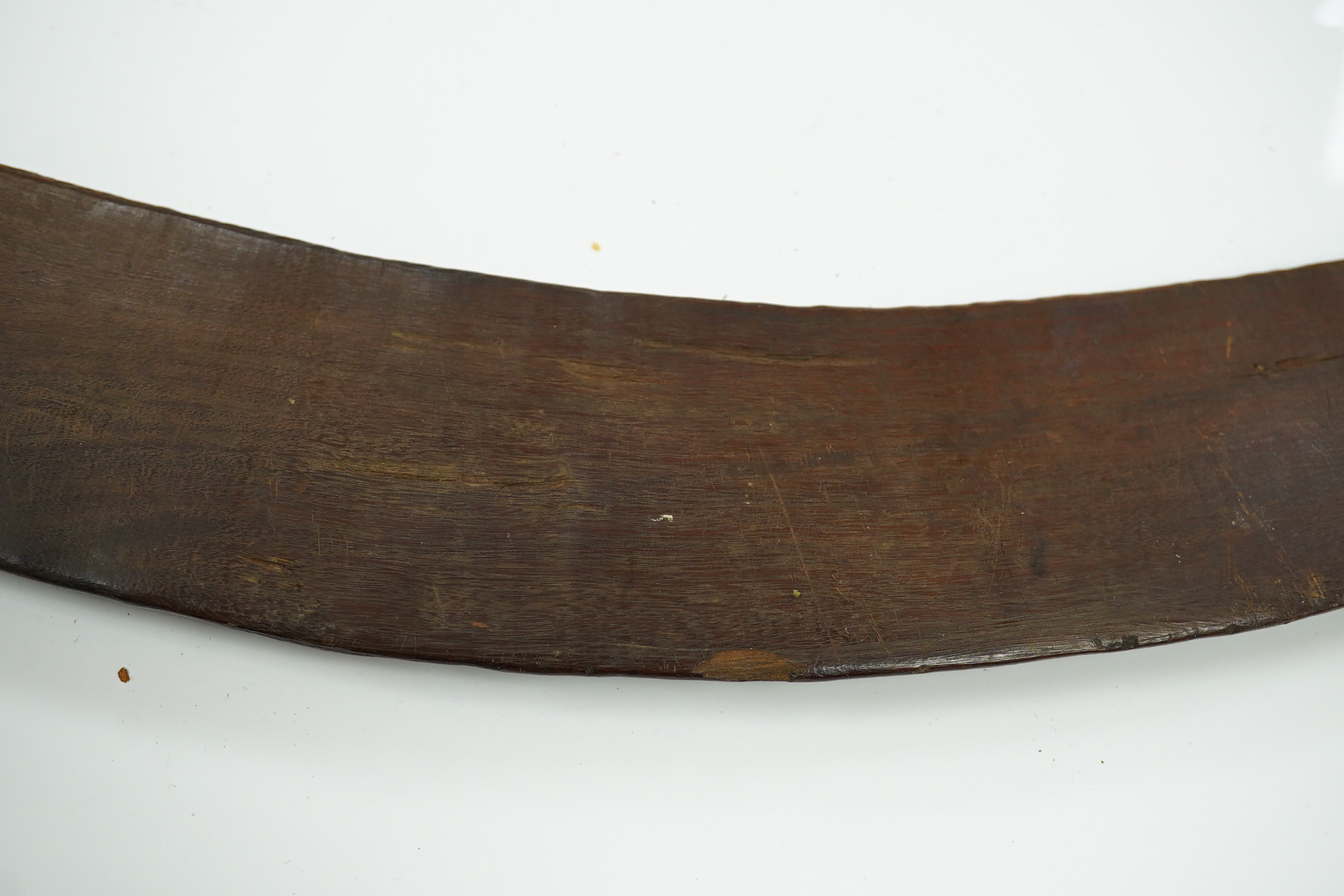 An Aboriginal boomerang, engraved to one side, 76cm wide. Condition - fair to good